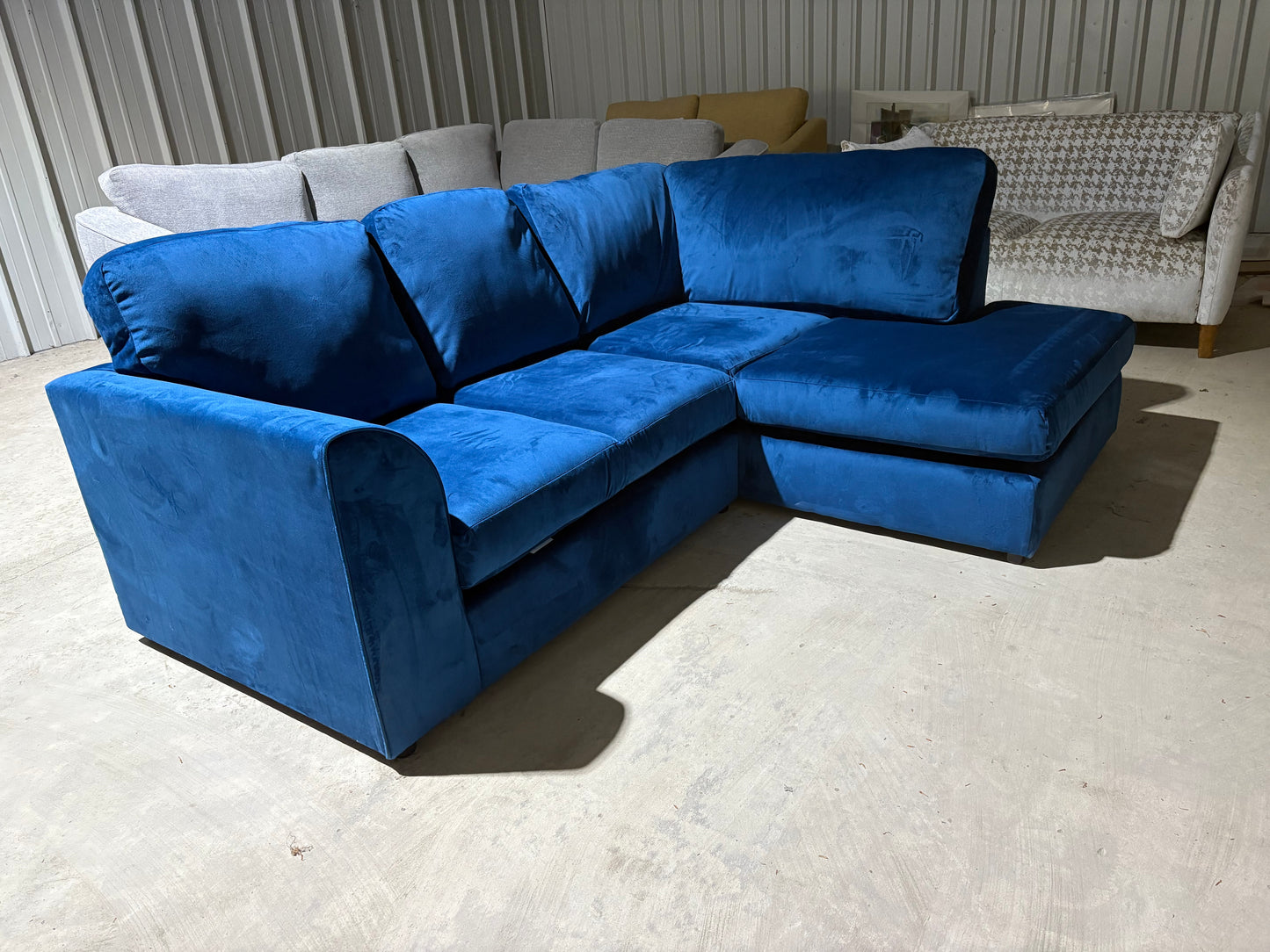 Corner sofa in striking blue velvet