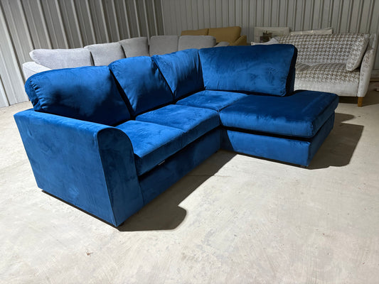 Corner sofa in striking blue velvet