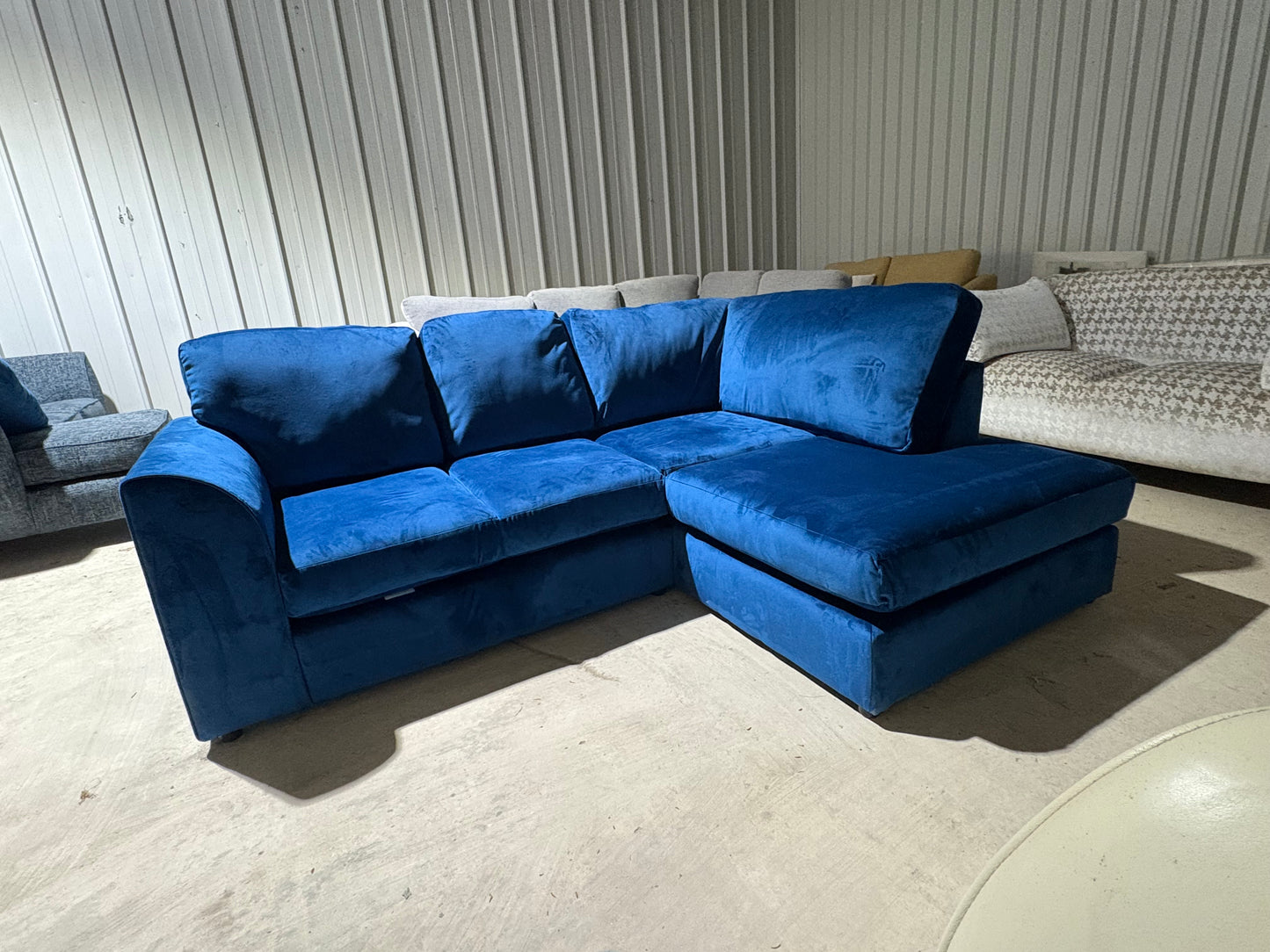 Corner sofa in striking blue velvet