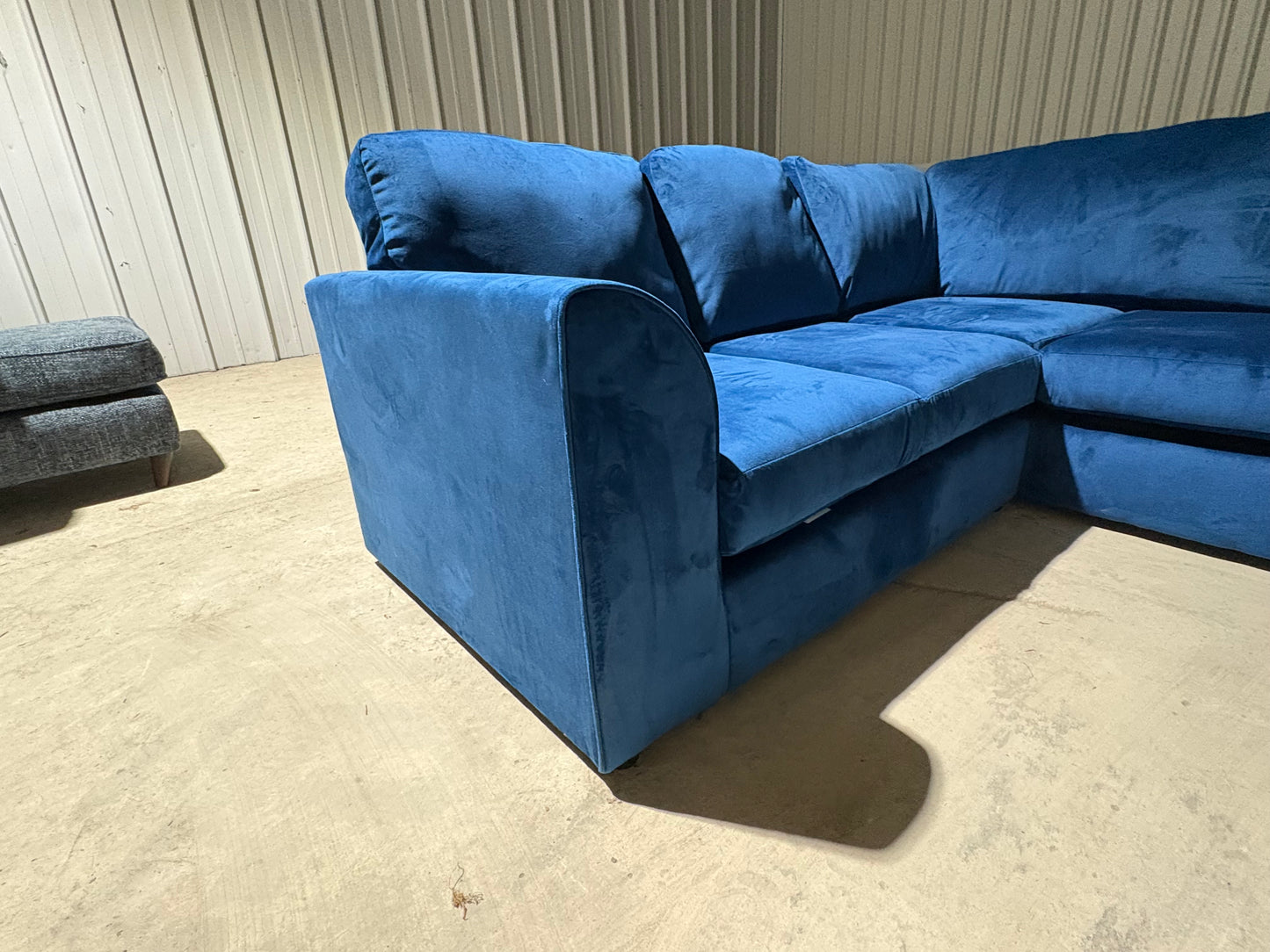 Corner sofa in striking blue velvet